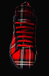 a red and black plaid sneaker on a black background