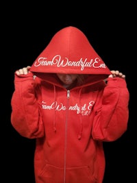 a woman wearing a red hoodie with the words'find us in you'on it