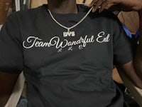 a man wearing a t - shirt that says team wonderful eat